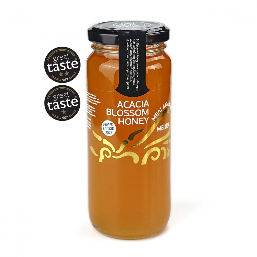 A glass jar filled with golden Acacia Blossom honey, showcasing its natural beauty and color. The label on the jar indicates the type of honey and its origin, capturing the essence of this sweet and delicate nectar.